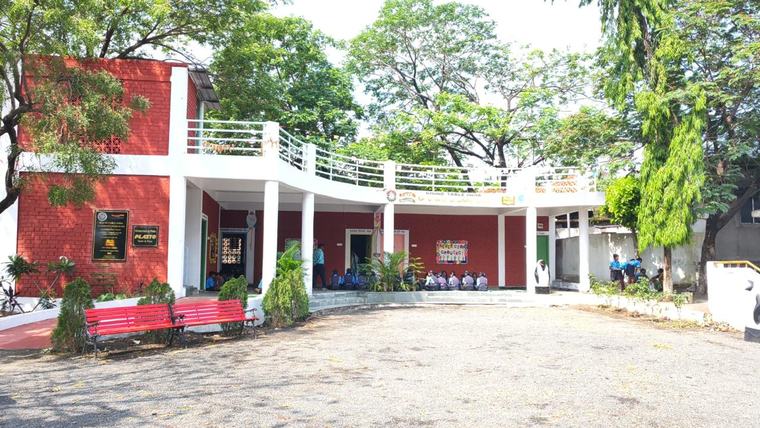 The finished Nagazari school with the trees grown in, children on the steps