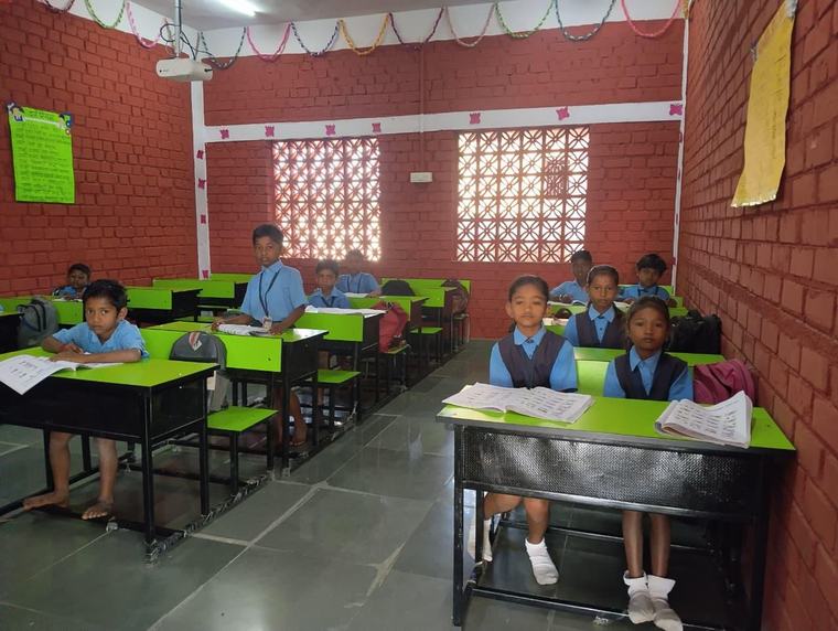 A class under way at the Nagazari school, children at their desks with their books open